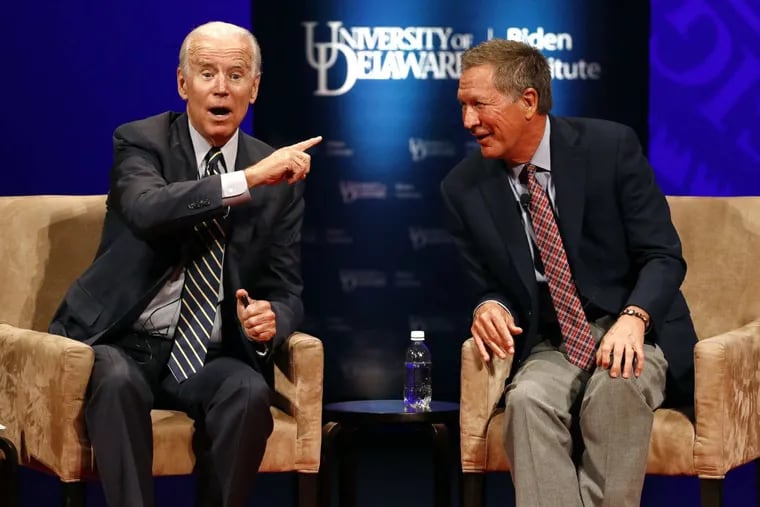 Former Vice President Joe Biden, left, and Ohio Gov. John Kasich as they participate in a discussion on bridging political and partisan divides at the University of Delaware Tuesday.
