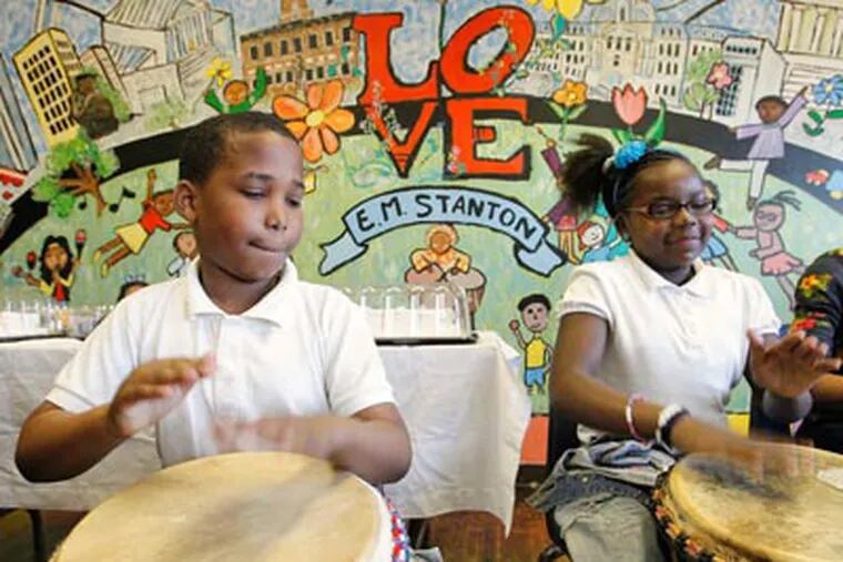 E.M. Stanton students Zafir Fuller (left) and Travonne Drayton, both 11, play drums during a celebration at the South Philadelphia school. ALEJANDRO A. ALVAREZ / Staff Photographer