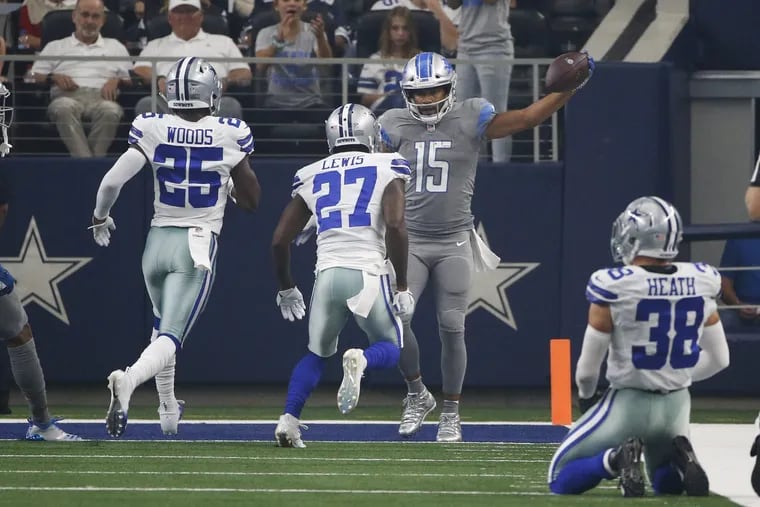 Detroit Lions wide receiver Golden Tate (15) celebrates a touchdown in front of Dallas Cowboys defensive back Xavier Woods (25) cornerback Jourdan Lewis (27) and defensive back Jeff Heath (38) in the first half of an NFL football game in Arlington, Texas, Sunday, Sept. 30, 2018.
