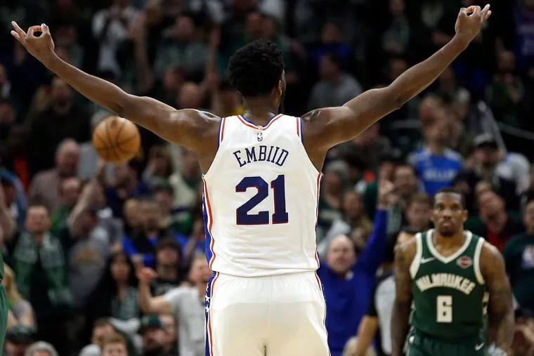 The 76ers' Joel Embiid reacts after making a shot against the Bucks on Sunday.