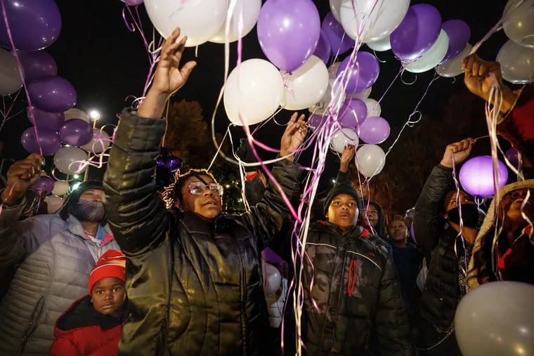 A friend of Jessica Covington releases balloons in her name at the Lawncrest Recreation Center on Monday night. Covington was shot and killed Saturday night as she unloaded baby shower gifts from her car Saturday night. She was expecting a girl.