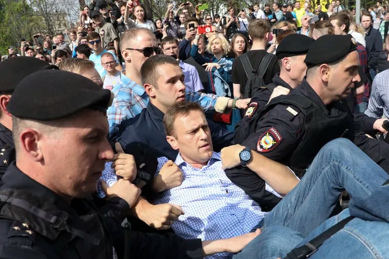 Russian police carrying opposition leader Alexei Navalny (center) from a demonstration against President Vladimir Putin in Pushkin Square in Moscow on May 5, 2018.