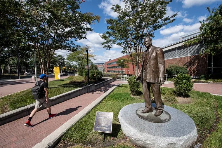 A students walks by the statue of Henry Rowan at Rowan University in Glassboro, N.J., in September.