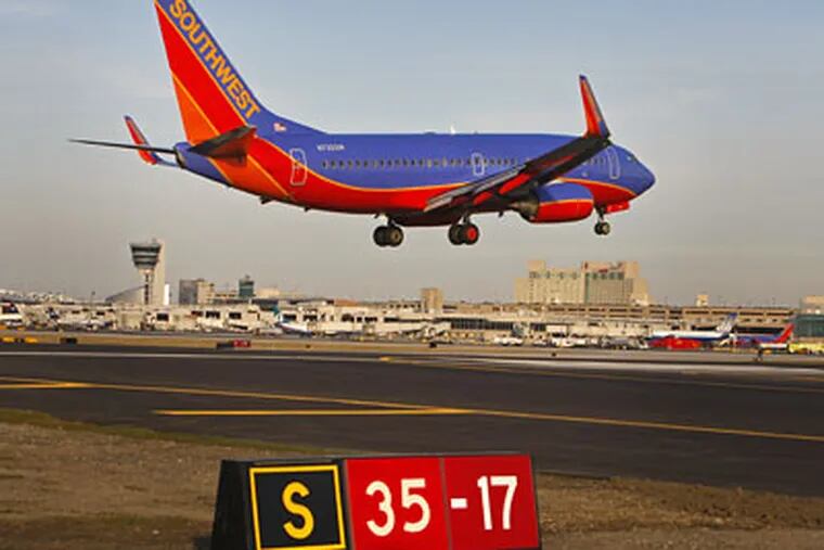 A Southwest jet lands on Runway 17-35 (the sign says 35-17 to tell pilots that taking off from this point would head them 350 degrees clockwise from due north). Now that 17-35 has been extended 1,040 feet, it can handle the Airbus A320s operated by US Airways. Before Feb. 12, only smaller craft could use it. (Michael S. Wirtz / Staff Photographer)