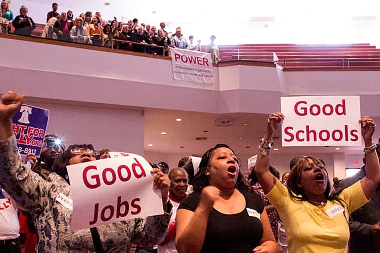 Crowds cheer Sunday at Deliverance Evangelistic Church in North Philadelphia, where Philadelphians Organized to Witness, Empower and Rebuild (POWER) rallied for better wages for airport workers. (Courtney Marabella/Staff)