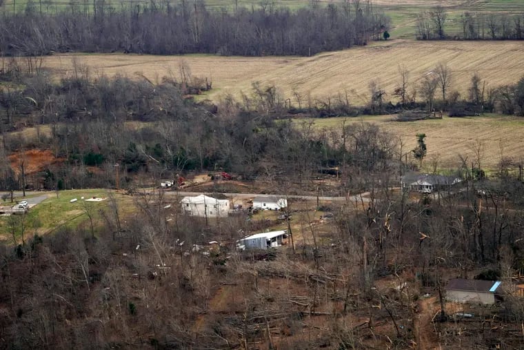 Storm damage from tornadoes and extreme weather is seen en route to the airport in Mayfield, Ky.