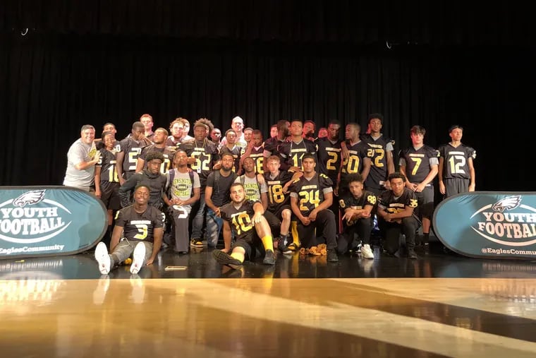 Kensington Football team with Eagles tight end Zach Ertz as they donate football equipment after theft