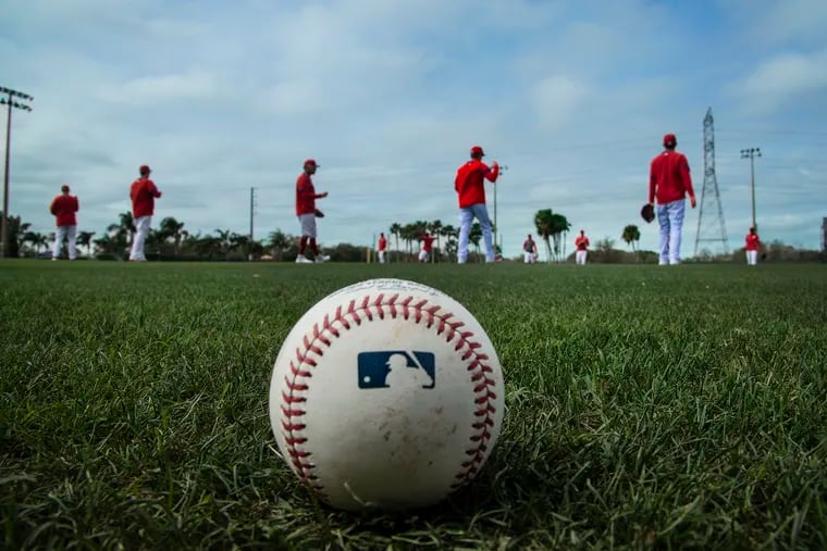 Phillies players warming up during the last day of spring training workouts in Clearwater on Feb. 21.