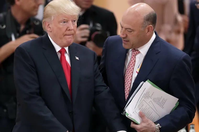 FILE – In this Saturday, July 8, 2017, file photo, White House chief economic adviser Gary Cohn, right, talks to U.S. President Donald Trump before a working session at the G-20 summit in Hamburg, Germany.