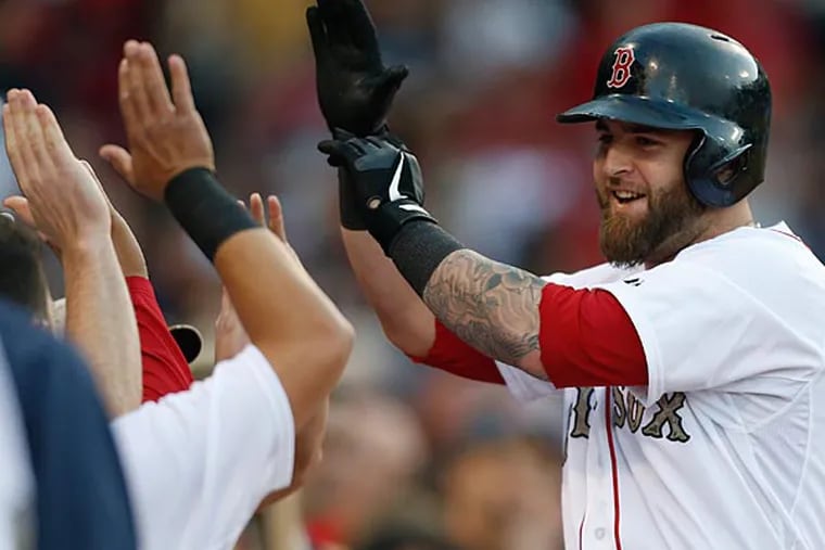 Boston Red Sox's Mike Napoli celebrates his solo home run in the first inning of a baseball game against the Philadelphia Phillies in Boston, Monday, May 27, 2013. (AP Photo/Michael Dwyer)