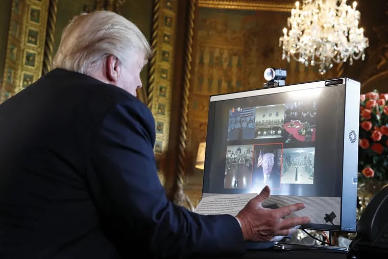 President Donald Trump speaks with troops via video conference from Mar-a-Lago, on Thanksgiving, Thursday, Nov. 23, 2017.