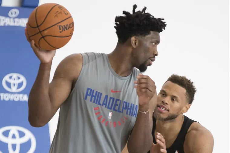 Sixers Joel Embiid (left) does a post-up drill with teammate Justin Anderson at the end of practice on Sept. 29.
