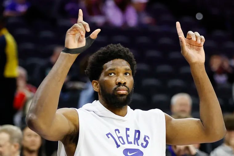 Sixers center Joel Embiid raises his fingers during warm-ups the before the Sixers play the Toronto Raptors in Game 5.