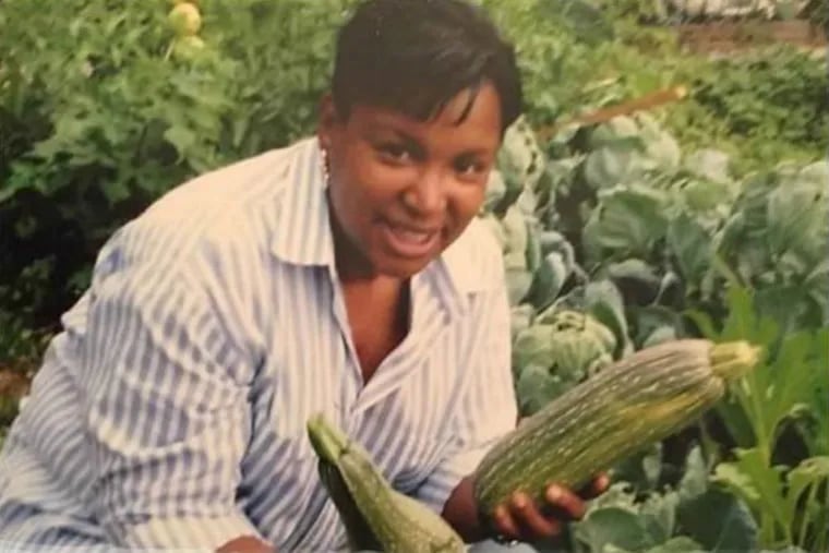 Winnie Harris with vegetables she grew in the Holly Street Neighbors Community Garden, which she founded in 2005.