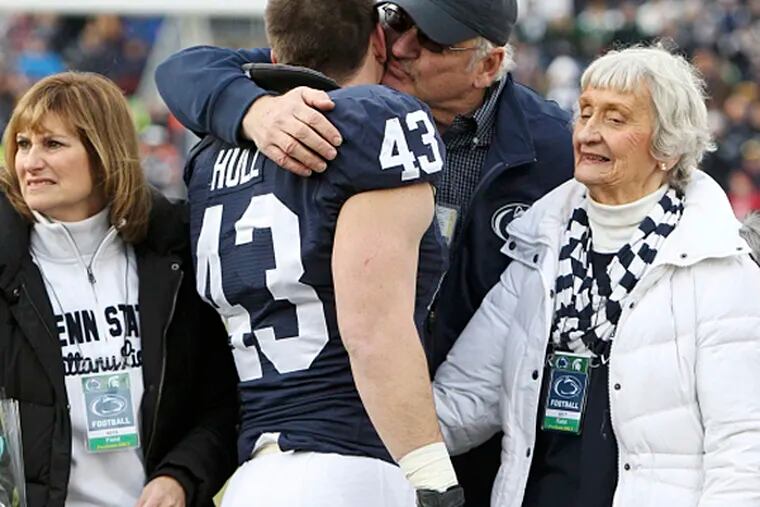 Penn State linebacker Mike Hull hugs a family member during the senior day festivities prior to the game against the Michigan State (Matthew O'Haren/USA TODAY Sports)