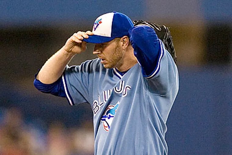 Blue Jays starting pitcher Roy Halladay pauses between pitches during the first inning of a baseball game against the Tampa Bay Rays in Toronto on Friday, July 24 2009. (AP Photo/The Canadian Press, Chris Young)