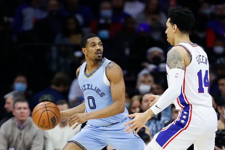 Memphis Grizzlies guard De'Anthony Melton holds the basketball against Sixers forward Danny Green on Monday, January 31, 2022 in Philadelphia.
