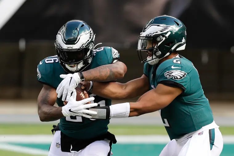 Miles Sanders (left) and Jalen Hurts will be the keys to the Eagles' run game Sunday against the Cowboys.