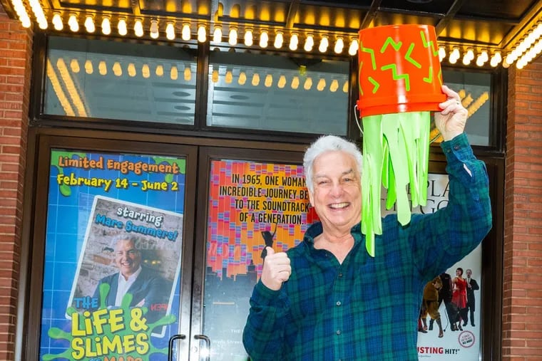 Marc Summers with a prop bucket of slime outside New World Stages in New York City.