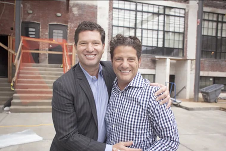 Sporting broad smiles are developer Eric Blumenfeld (left) and Joseph Volpe, whose Vie catering hall takes up part of the old Wilkie Buick site. (Ed Hille / Staff Photographer)