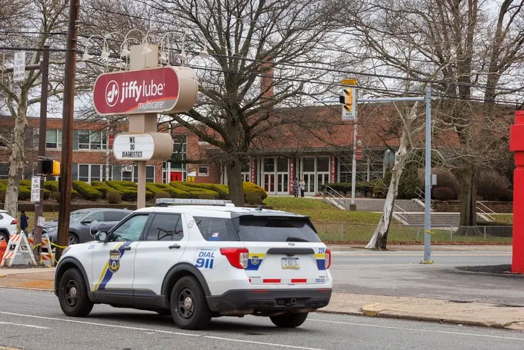 Philadelphia police cruiser drives near Northeast High School the day after eight students were shot at bus stop at Rising Sun and Cottman Avenues.