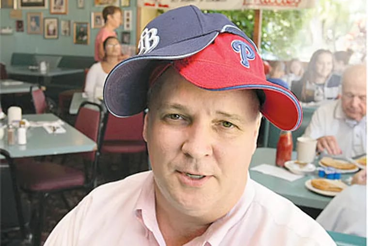 Kevin Schauer is general manager of Lenny's in Clearwater, Fla.  He wears both Phillies and Rays caps.