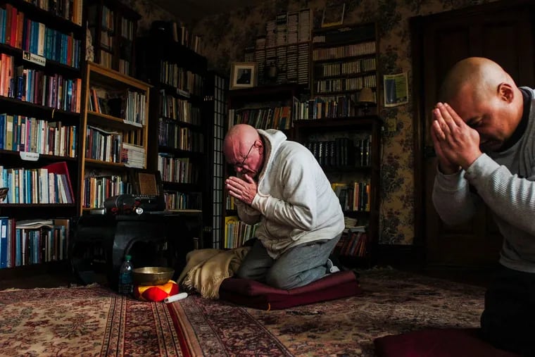 John Mulligan (left) and Angel Correa performing their daily meditation at Bodhi House in Mount Joy Township.