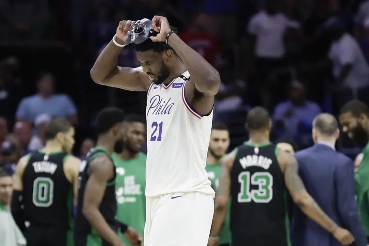 Sixers center Joel Embiid walks off the court after a disastrous turnover gave the Celtics the edge with seconds left in overtime of Game 3 on Saturday.