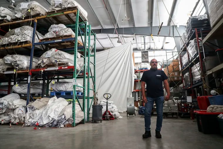 Owner Anthony Cianciculli stands in a warehouse filled with tents at Anthony Party Rentals in Norristown, Pa. on Monday, July 13, 2020.