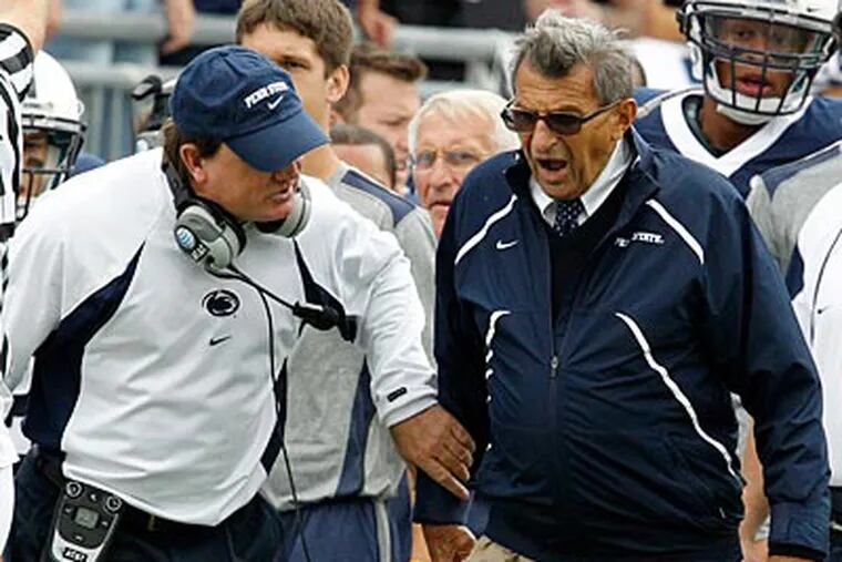 Joe Paterno, right, and assistant coach Tom Bradley, left, talk on the sidelines during a game in September. (Gene J. Puskar/AP file photo)
