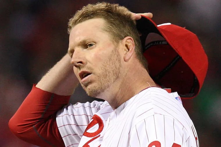 Roy Halladay wipes his face after a Cubs run scores during the fourth inning at Citizens Bank Park in Philadelphia, Friday, April 27, 2012. (Steven M. Falk/Staff Photographer)