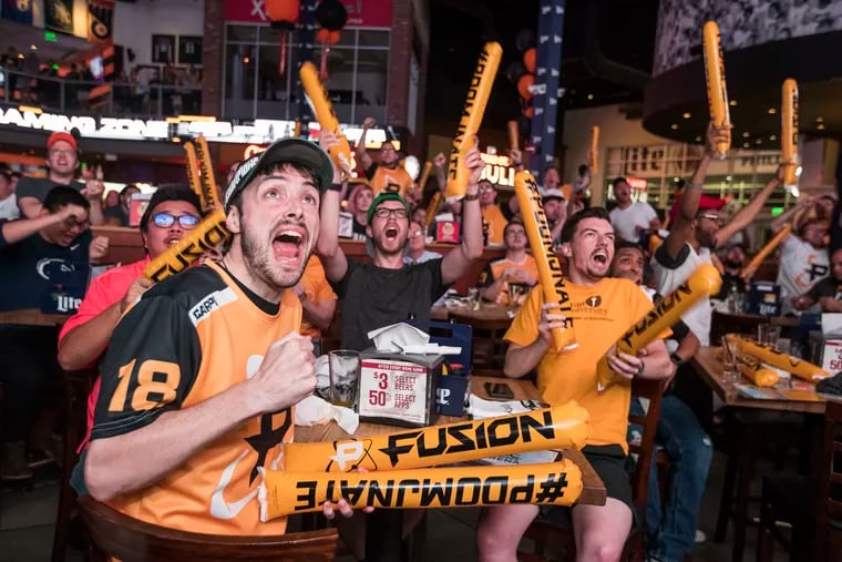 Philadelphia Fusion fans, including Ryan Parker, left, celebrate during the esports team's 3-1 victory over the Boston Uprising in the Overwatch League World Championship playoffs on July 11, 2018. To celebrate, NBC Sports Arena hosted a Philadelphia watch party for fans of the league at Xfinity Live! CHARLES FOX / Staff Photographer