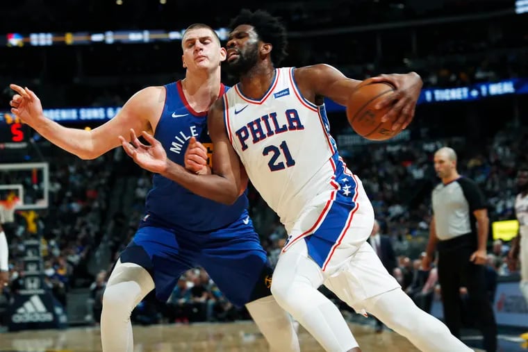 Sixers center Joel Embiid, seen here in 2019 against Nuggets center Nikola Jokic, has had a better (if shorter) season.