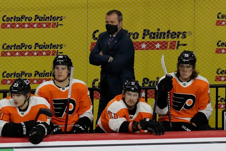 Flyers head coach Alain Vigneault watches his team finish its season with a 4-2 win over the New Jersey Devils on Monday.