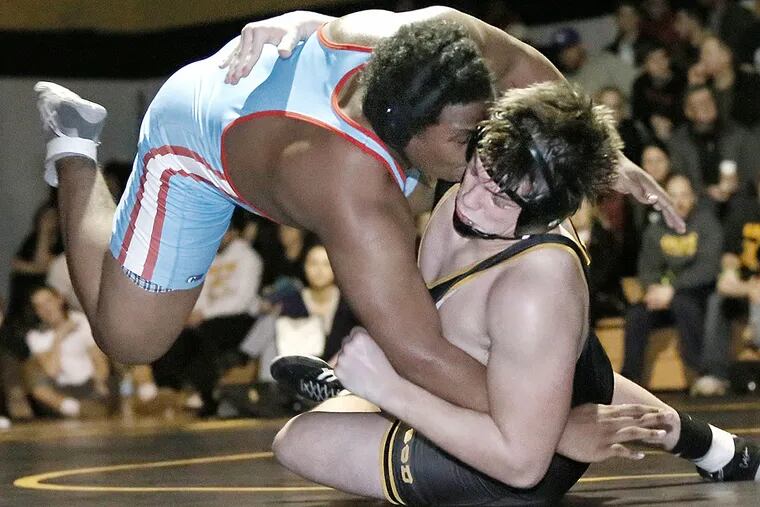 Archbishop Wood's Connor Bishop (bottom) wrestles Father Judge's Sean Armstrong.