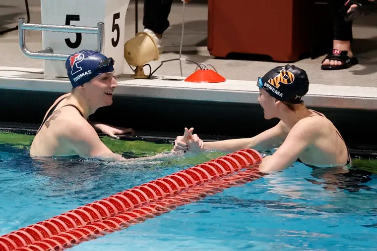 Penn's Lia Thomas (left) is congratulated by Princeton's Nikki Venema after Thomas won the 100-yard freestyle and Venema finished third at the Ivy League championships on Feb. 19, 2022.