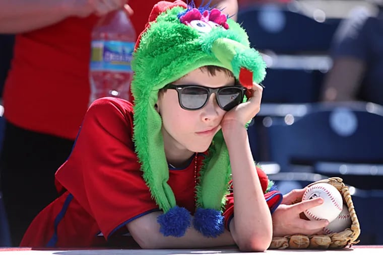 Ben Helfrich, of North Philadelphia, 9, leans on the Phillies dugout roof. (Michael Bryant/Staff Photographer)
