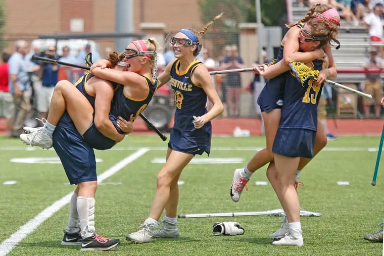 Unionville players celebrate on the field after the Indians won the PIAA Class 3A girls lacrosse championship.