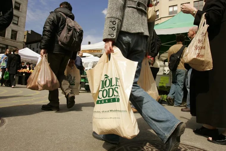 Female shoppers carry their groceries — and other bags. (AP Photo/Julie Jacobson)