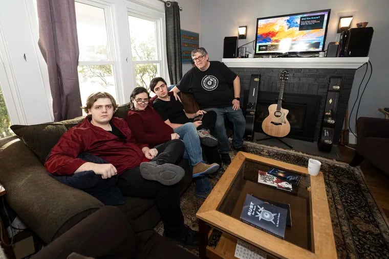 Pier and Jennifer Giacalone with their two sons, Ben (left) and Rolley in the living room of their home in Doylestown.