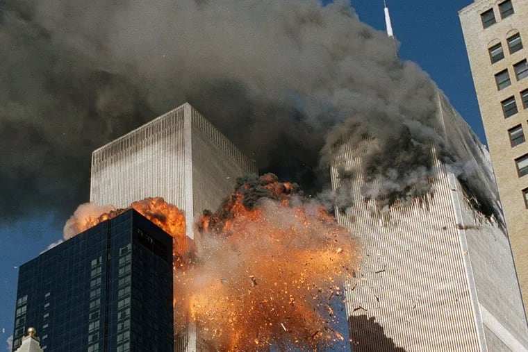 In this Sept. 11, 2001 file photo, smoke billows from World Trade Center Tower 1 and flames explode from Tower 2 as it is struck by American Airlines Flight 175.