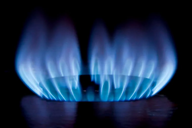 A gas flame burns on a stove.