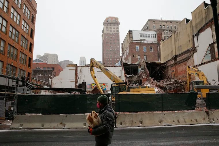 A pedestrian walks near the demolition walks across from  204 South 12th Street, the former building of the Residence & Restaurant of Henry S. Minton and the 12th Street Gym on Sunday, January 31, 2021.