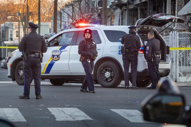 Philadelphia police patrol near a crime scene in December. The city may change how it coordinates its public safety response by creating a public safety director.