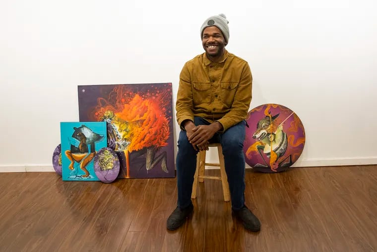 Philly artist Yis "Nosego" Goodwin poses for a portrait next to his artwork at the Paradigm Gallery + Studio in South Philadelphia on Tuesday, Dec. 11, 2018. Goodwin will launch his first local exhibition in three years on Dec. 14. HEATHER KHALIFA / Staff Photographer