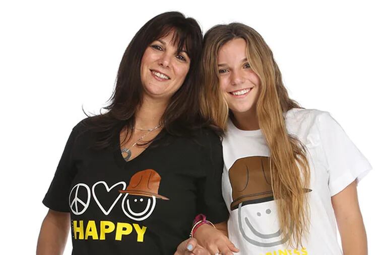 Lisa Lipson, left, and Victoria Lipson, right, in Peace Love World t-shirts inspired by Pharrell's song "Happy." ( MICHAEL BRYANT / Staff Photographer )