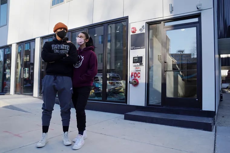 Tyler Shaide and Sophia DiLorenzo stand outside the Moscow & Monica apartments, where they are tenants, on Tuesday. Shaide and a number of other residents say they were scammed by the buildings' property manager.