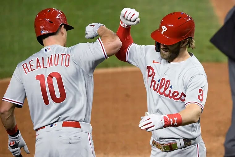 Bryce Harper (right) celebrates his home run with J.T. Realmuto in the sixth inning Wednesday night in Washington.
