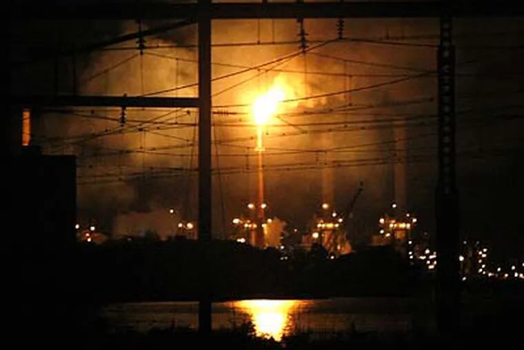 Flames from the explosion could be seen as far as 10 miles away from the refinery. (Ron Cortes/Staff Photographer)