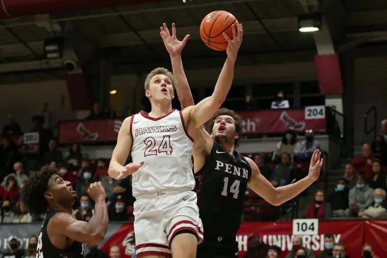 Jack Forrest of St. Joseph's goes up for a shot between Lucas Monroe (left) and Max Martz of Penn on Dec. 8.